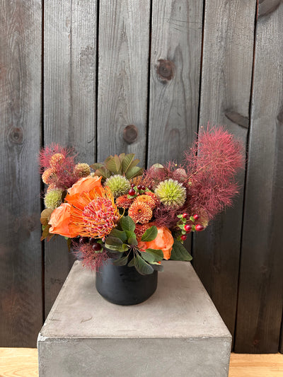 a fun modern floral arraignment with all sorts of cool shit. smoke bush, dahlias, thistle, pin cushions, berries, mums