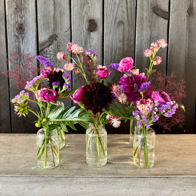 perfect purples and plum stems arranged in the modern glass bud vases