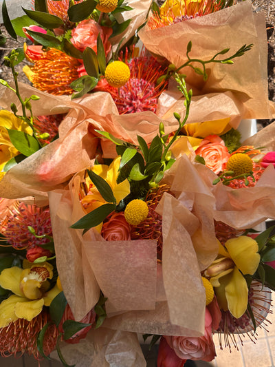 bright spring flowers 0 yellows, oranges, reds, pinks bouquets packed and ready for delivery. 