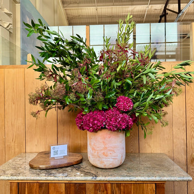 pink hydrangea nd greenery in a huge flower arrangement for greens restaurant 