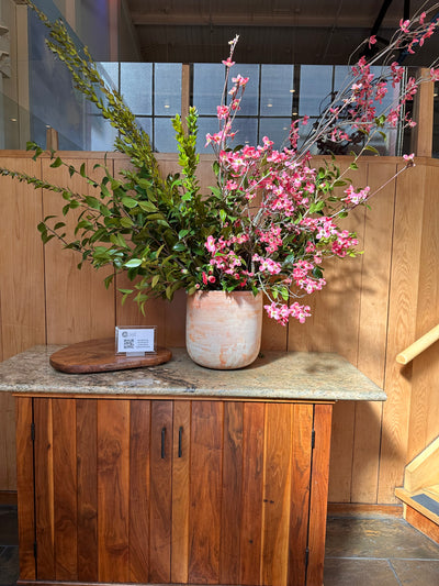 branches and dogwoods arranged tall for the entrance of greens restaurant