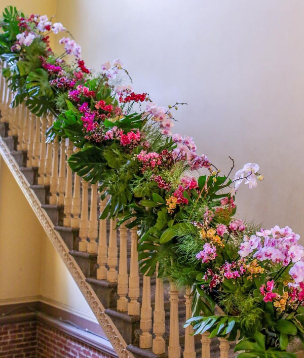 stairway of The Mint in sanfrancisco decorated with real orchid plants for a multi day installation by acme floral co San Francisco 