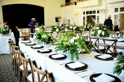the bride asked for graphic arrangments in all whites and greens with movement. monstera leaves, hydrangea, orchids, grasses and other fun leaves